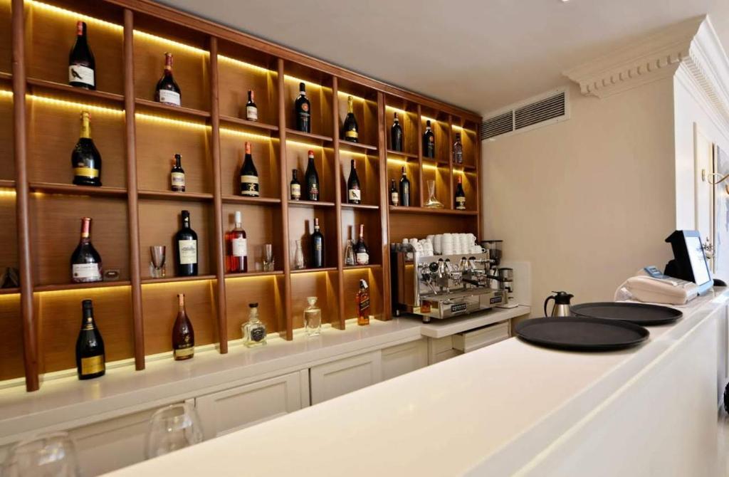 a bar with a display of wine bottles at Alis Hotel in Shkodër