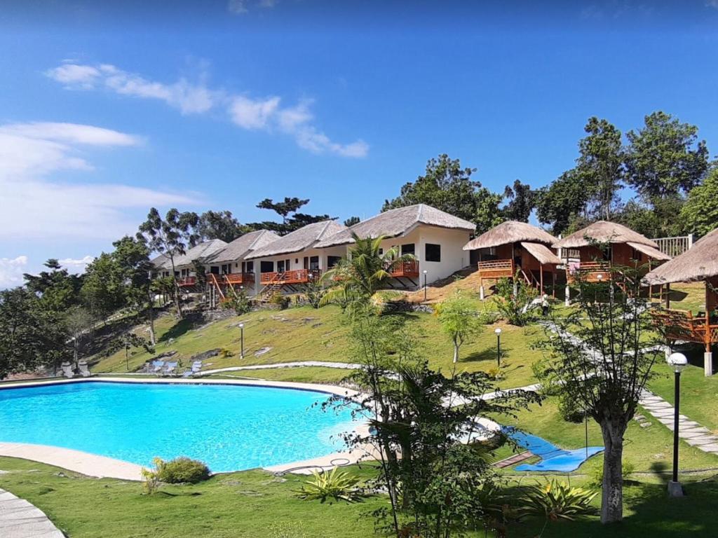 a view of a resort with a swimming pool at Cuestas Beach Resort and Restaurant in Badian