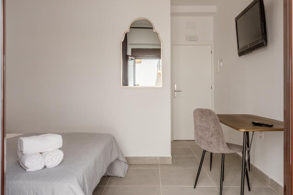 TV a/nebo společenská místnost v ubytování Villamarta Boutique Rooms