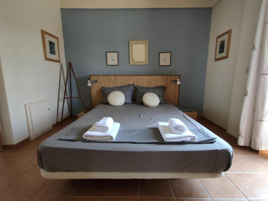 1 dormitorio con 1 cama con 2 toallas en Philos House, en AgiaKampos
