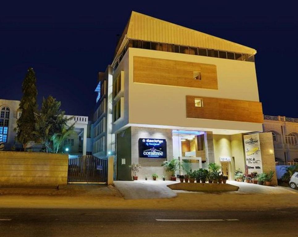 a building on the side of a street at night at Coraltree Hotel Bangalore in Bangalore