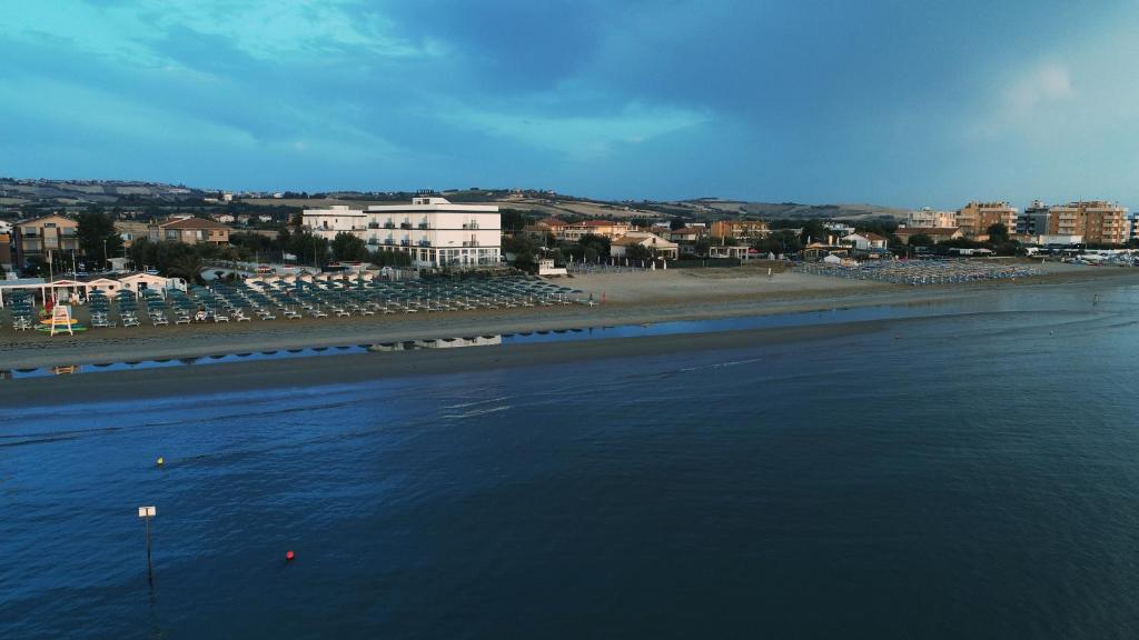 a view of a beach with boats in the water at Hotel Internazionale in Marotta