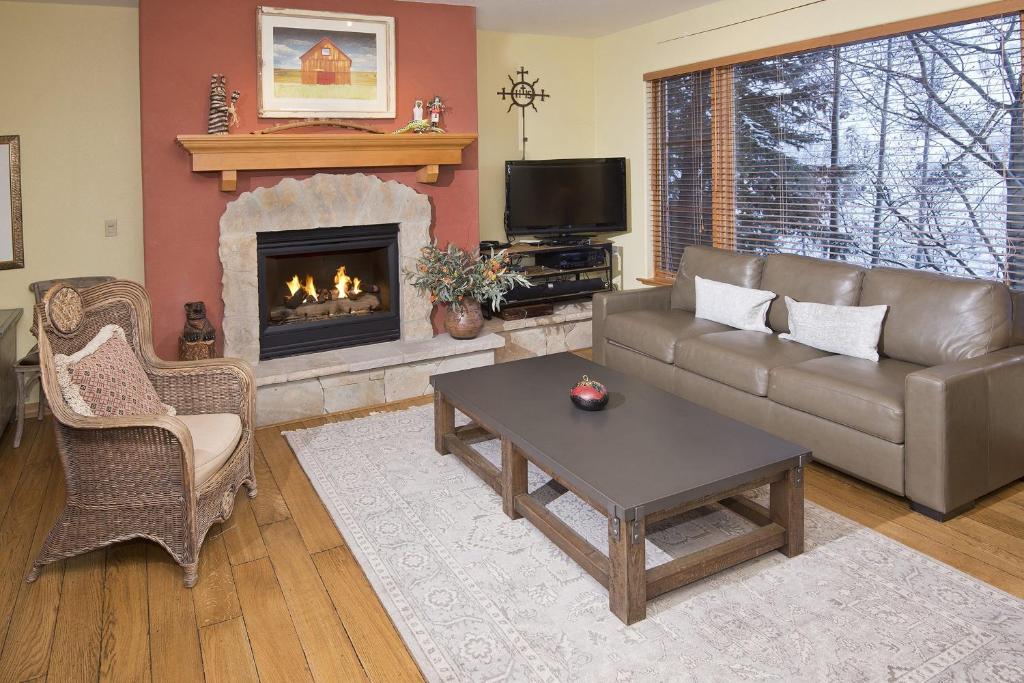 a living room with a couch and a fireplace at Aspenwood Lodge #201 Condo in Edwards