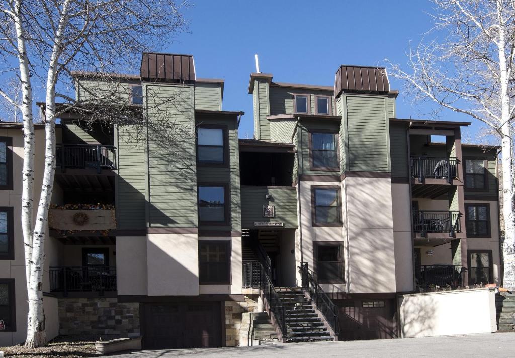 an apartment building with stairs in front of it at Breakaway West #212 condo in Vail