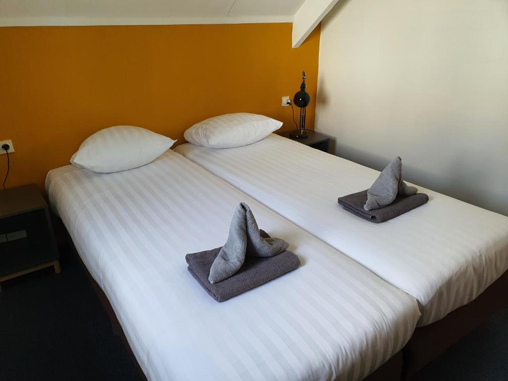 Postel nebo postele na pokoji v ubytování Zorn Hotel Duinlust