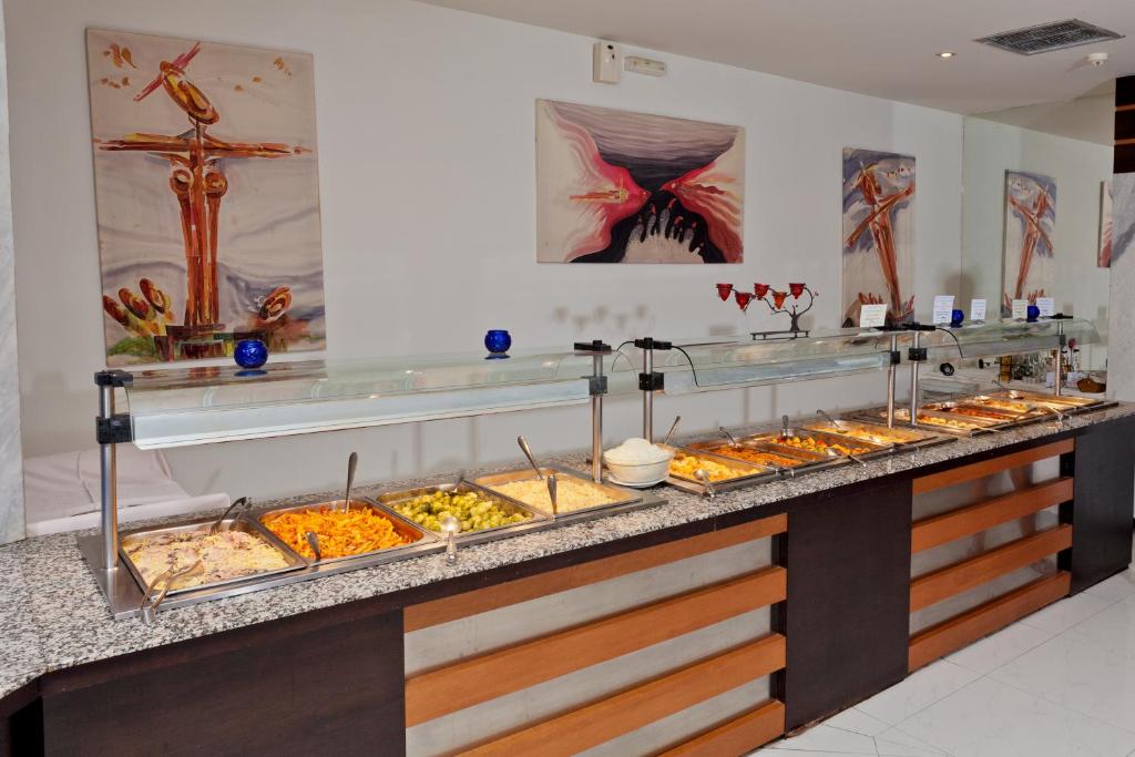 a buffet line with many different types of food at Cathrin Hotel in Faliraki