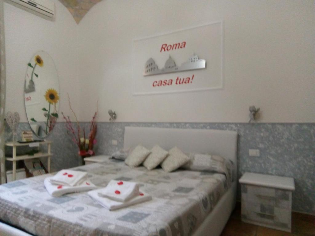 - une chambre avec un lit et des serviettes dans l'établissement Little House Roma, à Rome