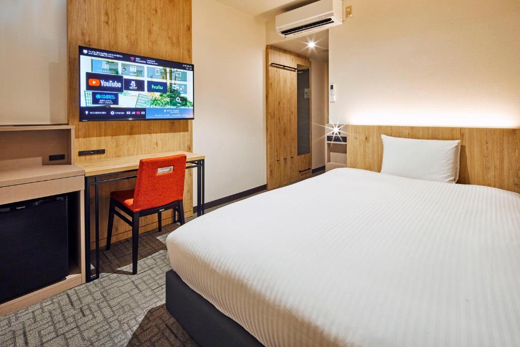 Postel nebo postele na pokoji v ubytování Hotel Lumiere Kasai