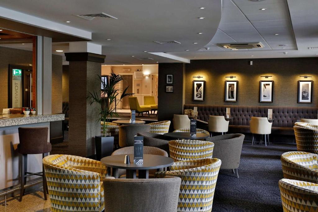 a restaurant with tables and chairs and a bar at Best Western Manchester Altrincham Cresta Court Hotel in Altrincham