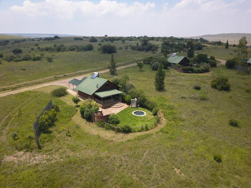 an aerial view of a house in the middle of a field at Stone Hill in Magaliesburg