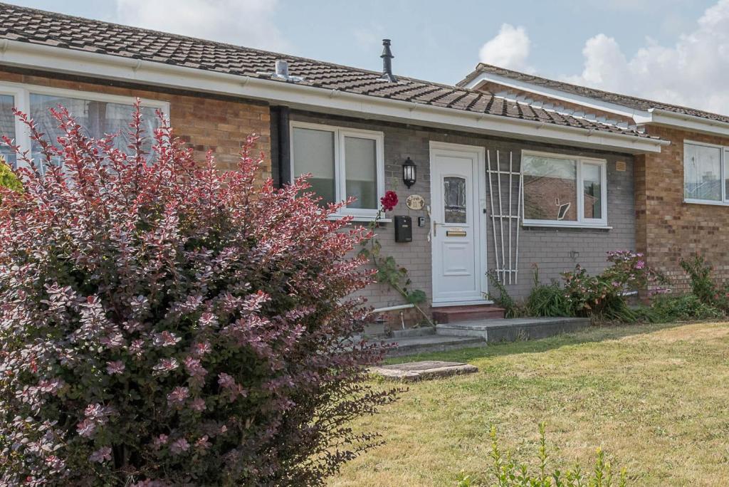 a brick house with a white door at Sea Dream House Kessingland Air Manage Suffolk in Lowestoft