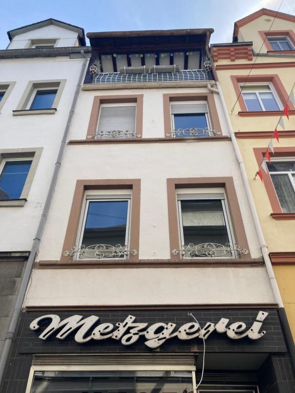 a building with a sign for a restaurant at Haus Alte Metzgerei in Zell an der Mosel
