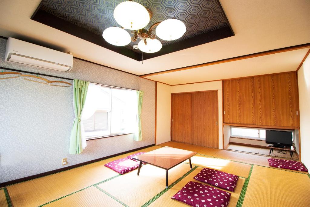 a living room with a table and a window at Habitacion NIIYA Mt Fuji in Fujikawaguchiko