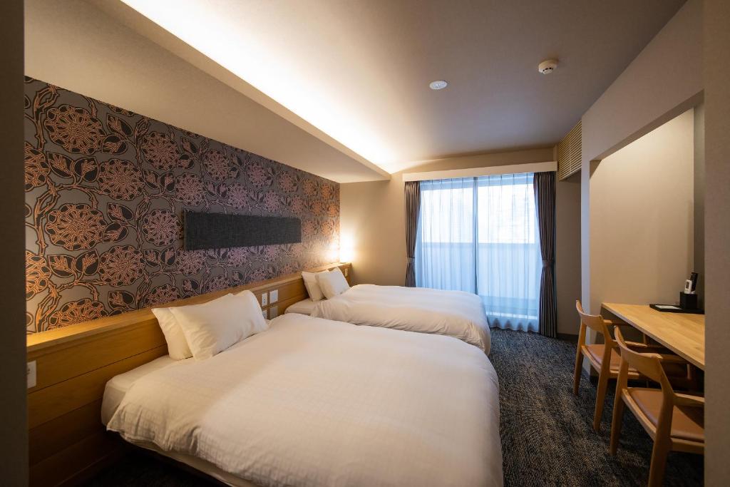 Postel nebo postele na pokoji v ubytování Hotel Celeste Shizuoka