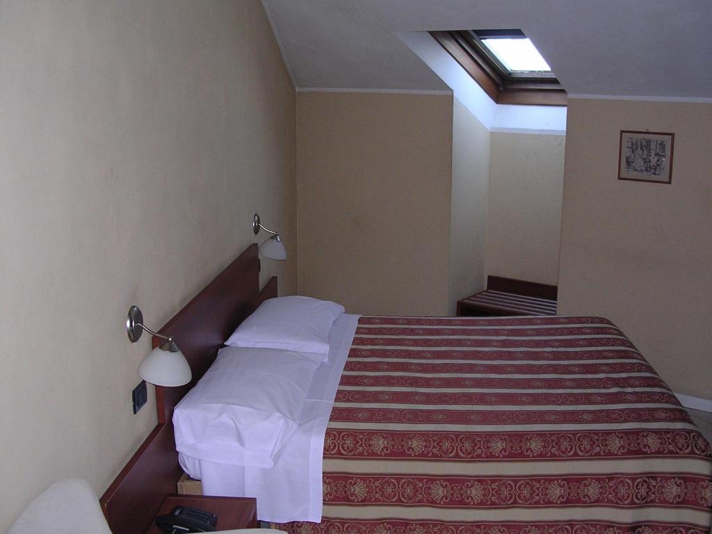 Postel nebo postele na pokoji v ubytování CerrutiHotel