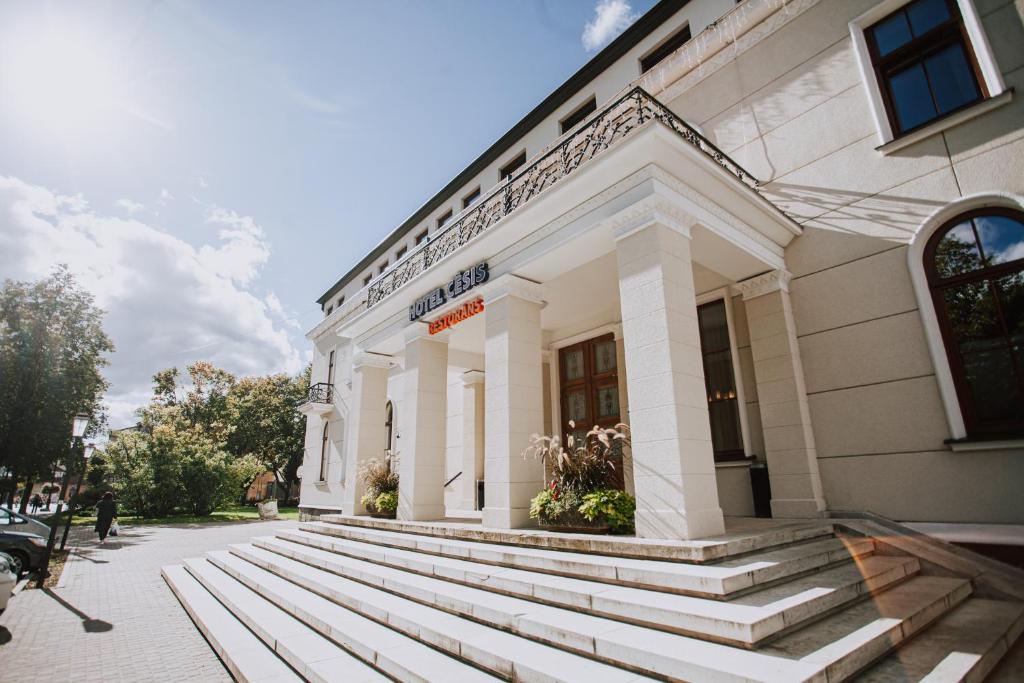 a white building with steps in front of it at Hotel Cēsis in Cēsis