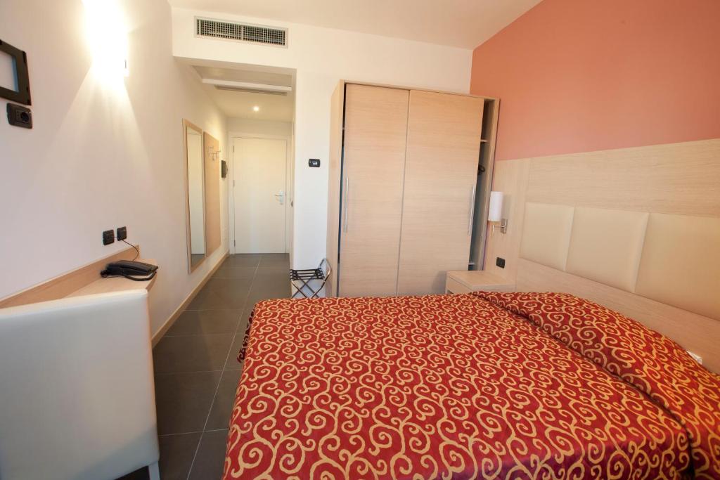 Postel nebo postele na pokoji v ubytování Hotel Eridano