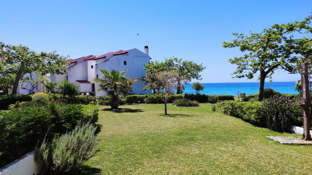 a view of a house with the ocean in the background at Anemi Beach, Seafront in Nea Skioni