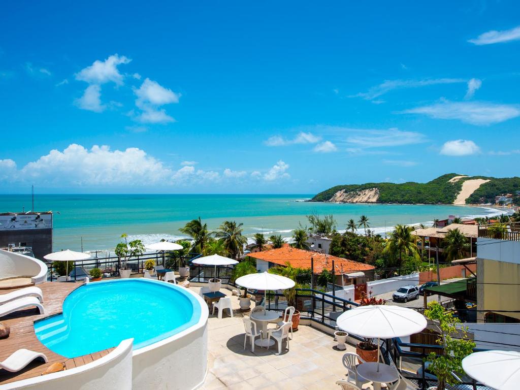 a view of the beach from a resort with a swimming pool at Rede Andrade Bello Mare in Natal