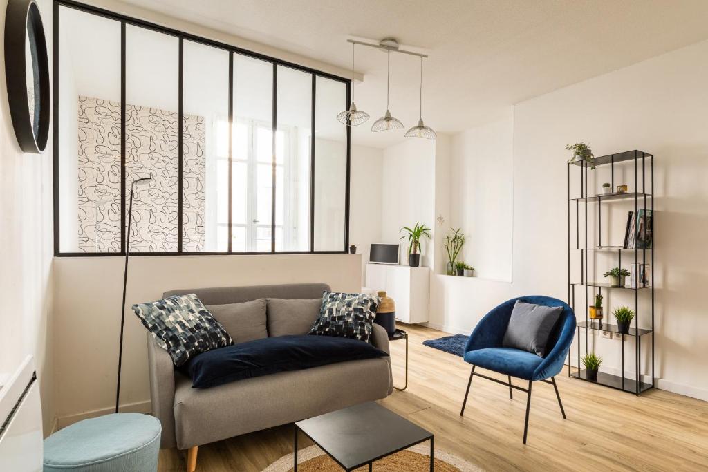 un salon avec un canapé et une chaise dans l'établissement DIFY Victoire, à Lyon