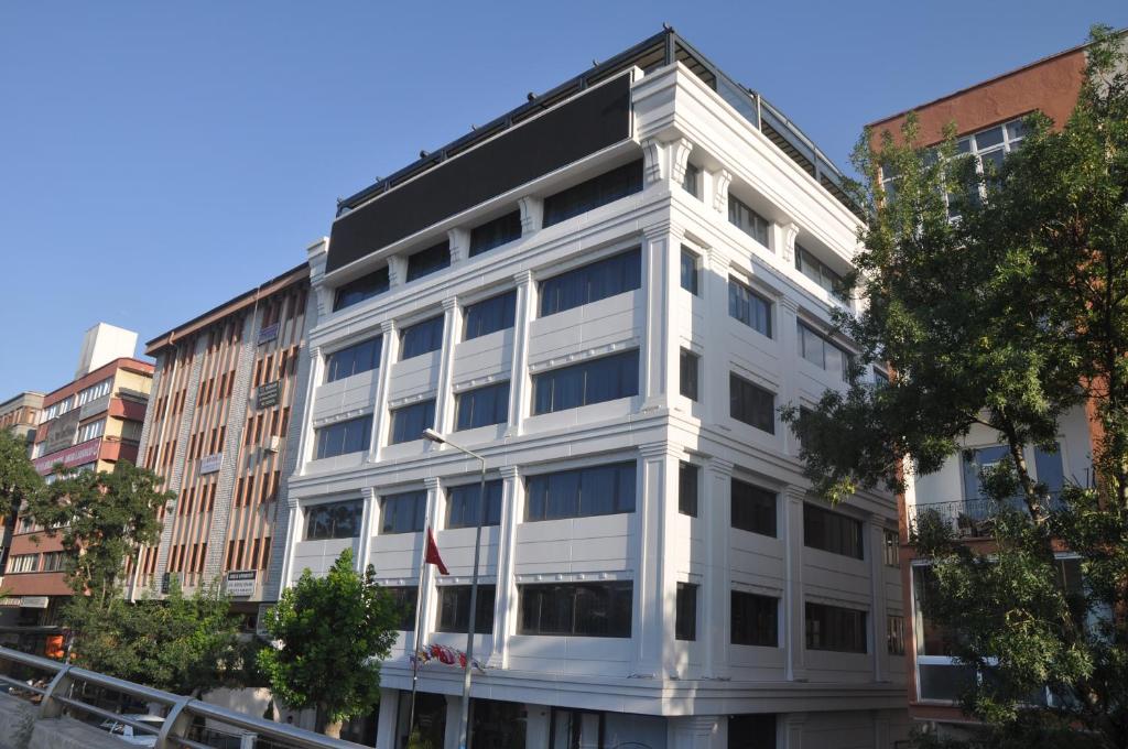 a white building in the middle of a city at GOLAZ SUİT OTEL in Ankara