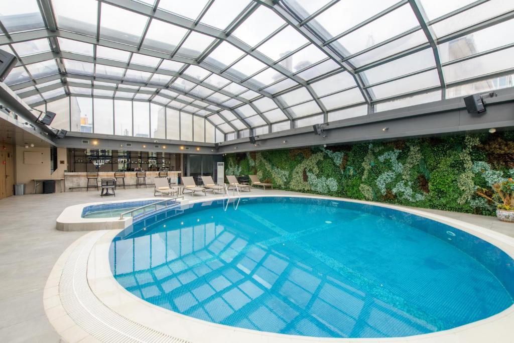 a large swimming pool with a glass ceiling at Golden Age Hotel Taksim in Istanbul