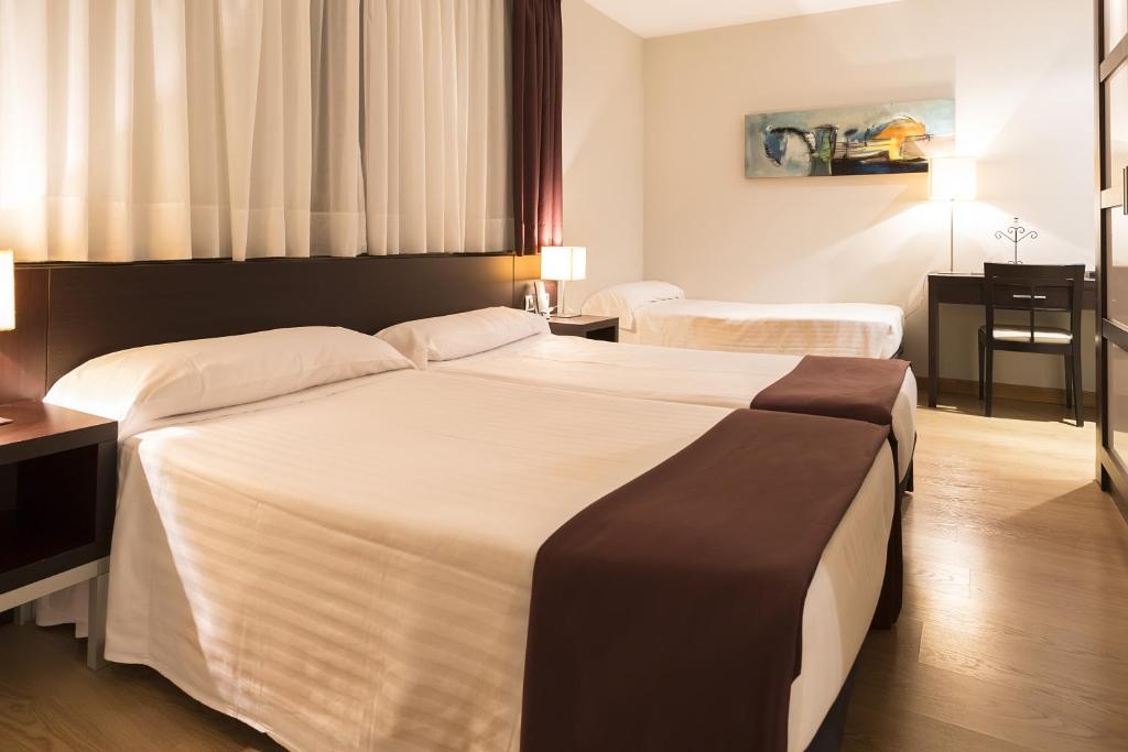 Postel nebo postele na pokoji v ubytování Hotel Plazaola