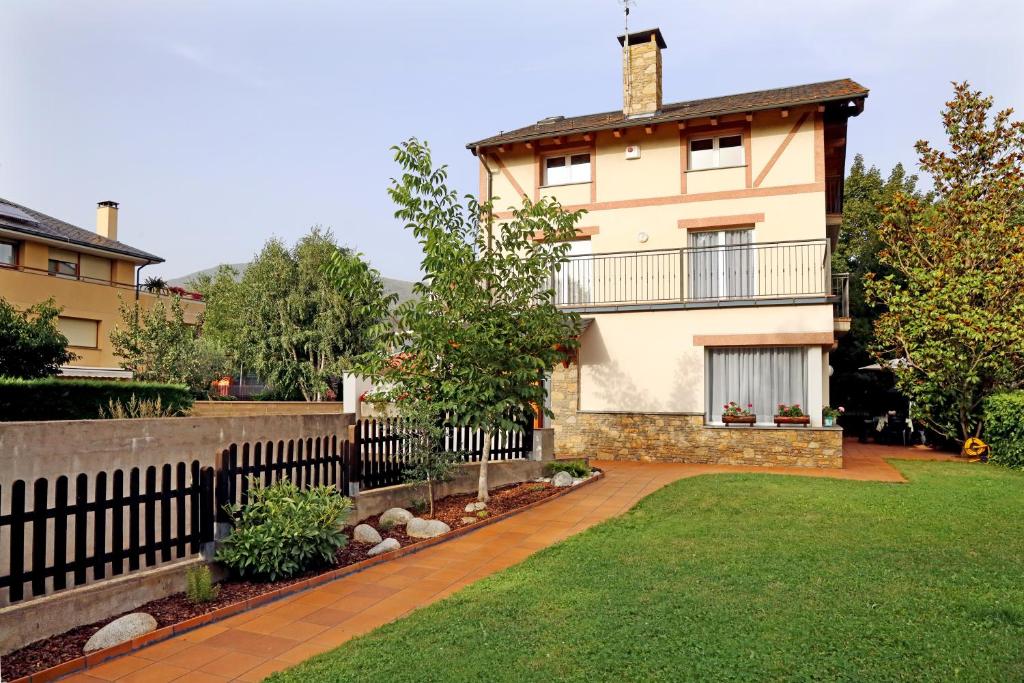 a house with a fence in front of a yard at Casa Escardill in La Seu d'Urgell