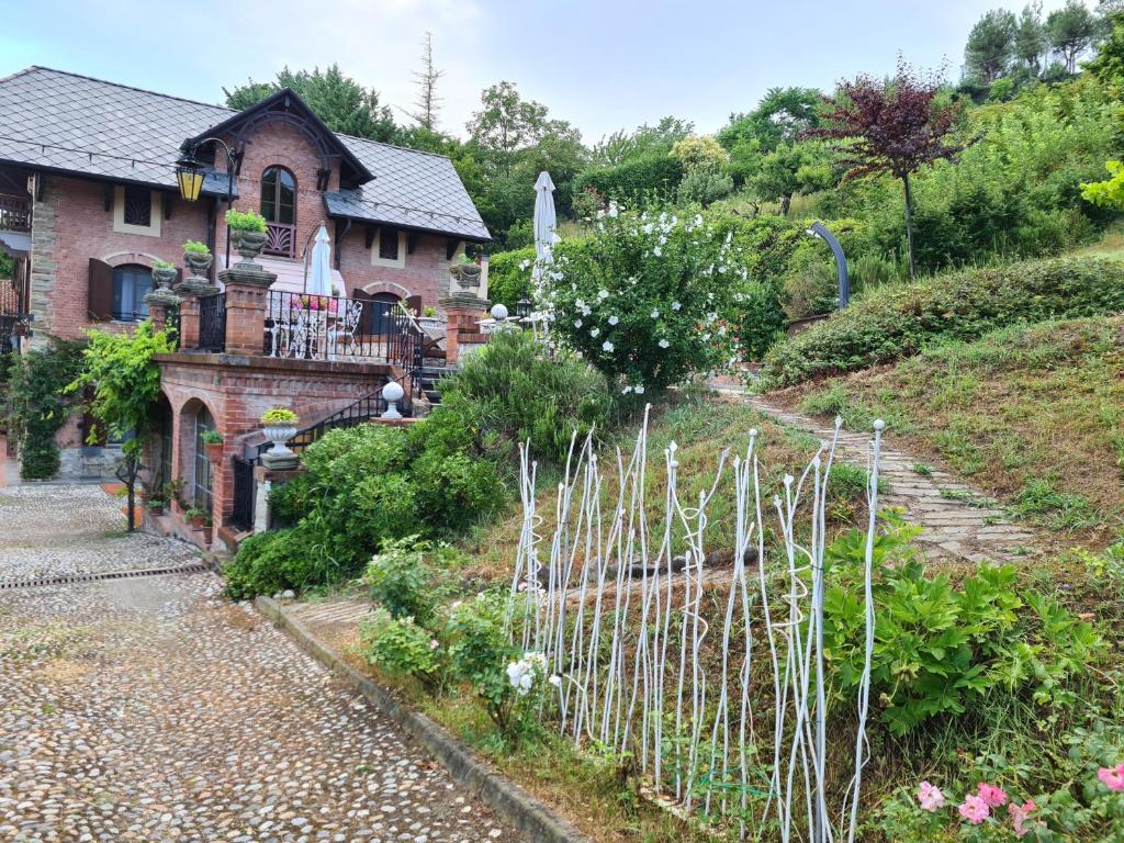 uma casa com uma cerca em frente a um jardim em Villa La Favorita em Alba