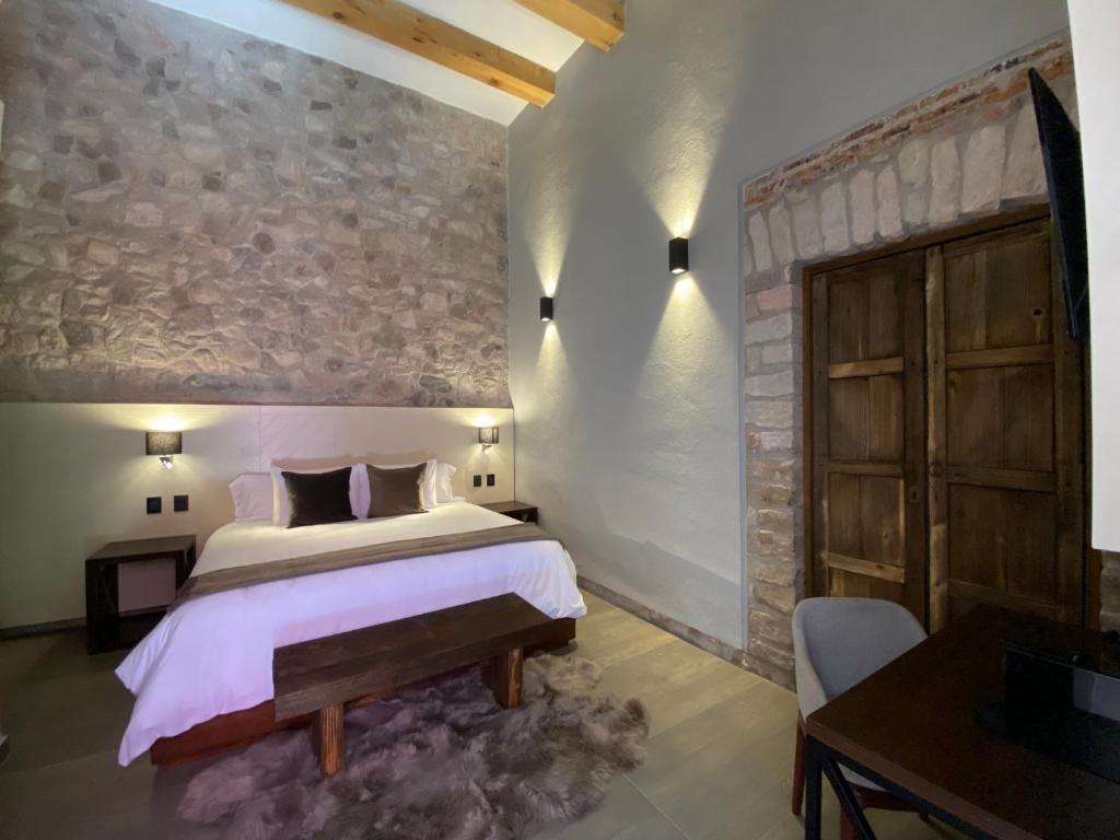 Postel nebo postele na pokoji v ubytování Hotel Casa Once