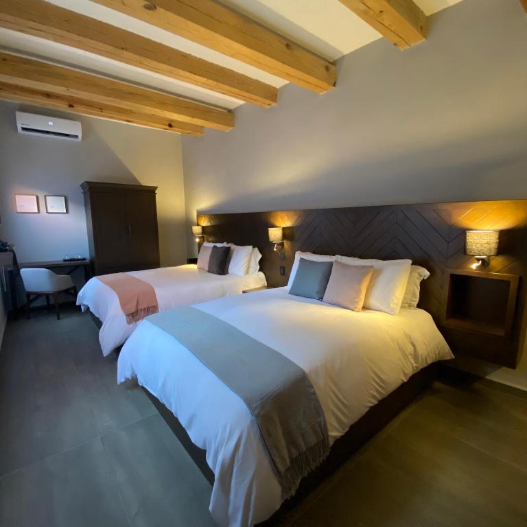 Postel nebo postele na pokoji v ubytování Hotel Casa Once