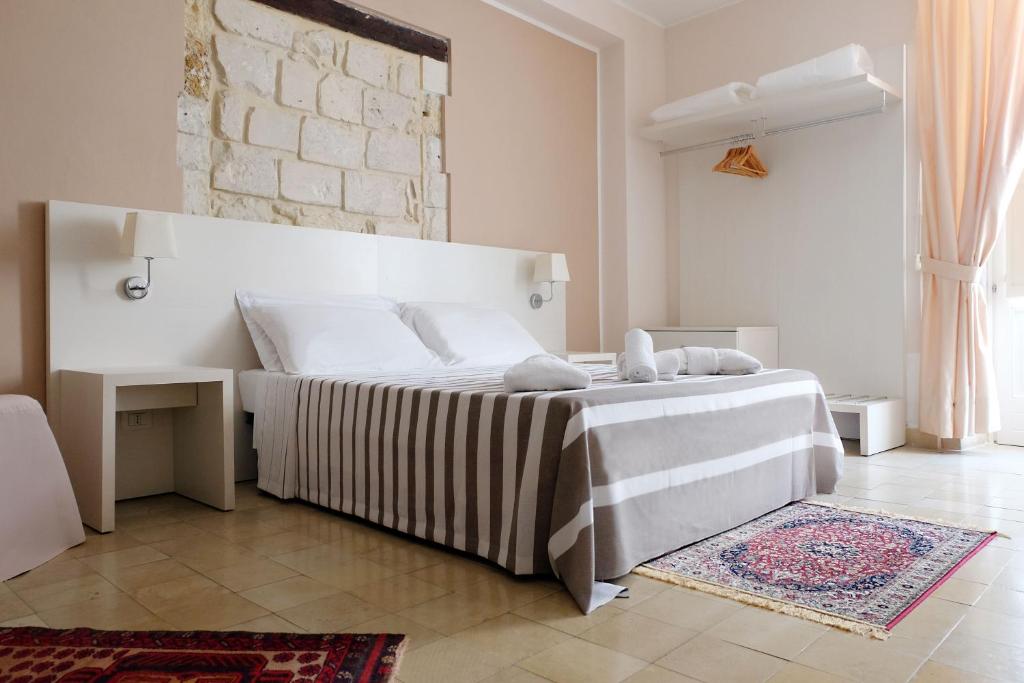 Łóżko lub łóżka w pokoju w obiekcie Nuova Mastrarua Rooms