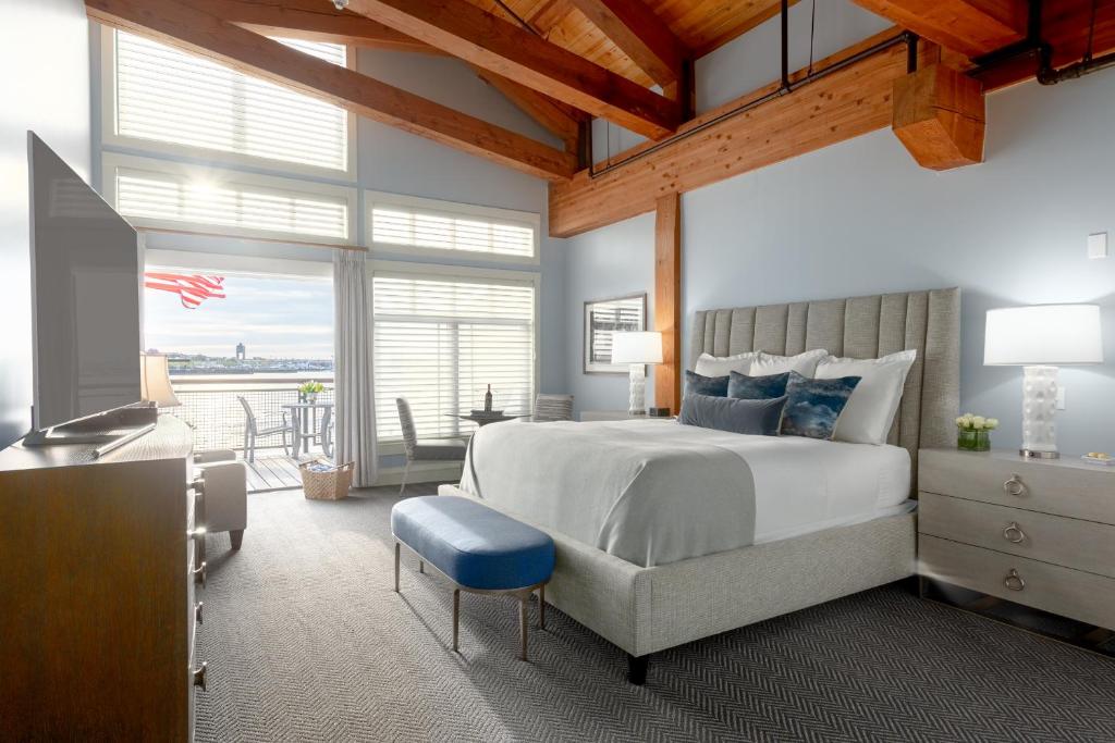 a bedroom with a large bed with a blue stool at Boston Yacht Haven in Boston