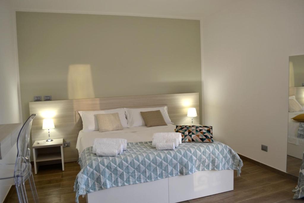a bedroom with a large bed with two pillows at B&B Trepo Santa Domenica in Santa Domenica