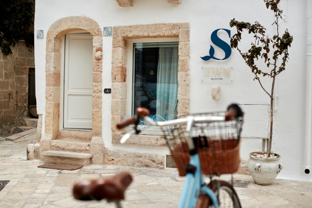 una bici blu parcheggiata di fronte a un negozio di Dei Serafini a Polignano a Mare