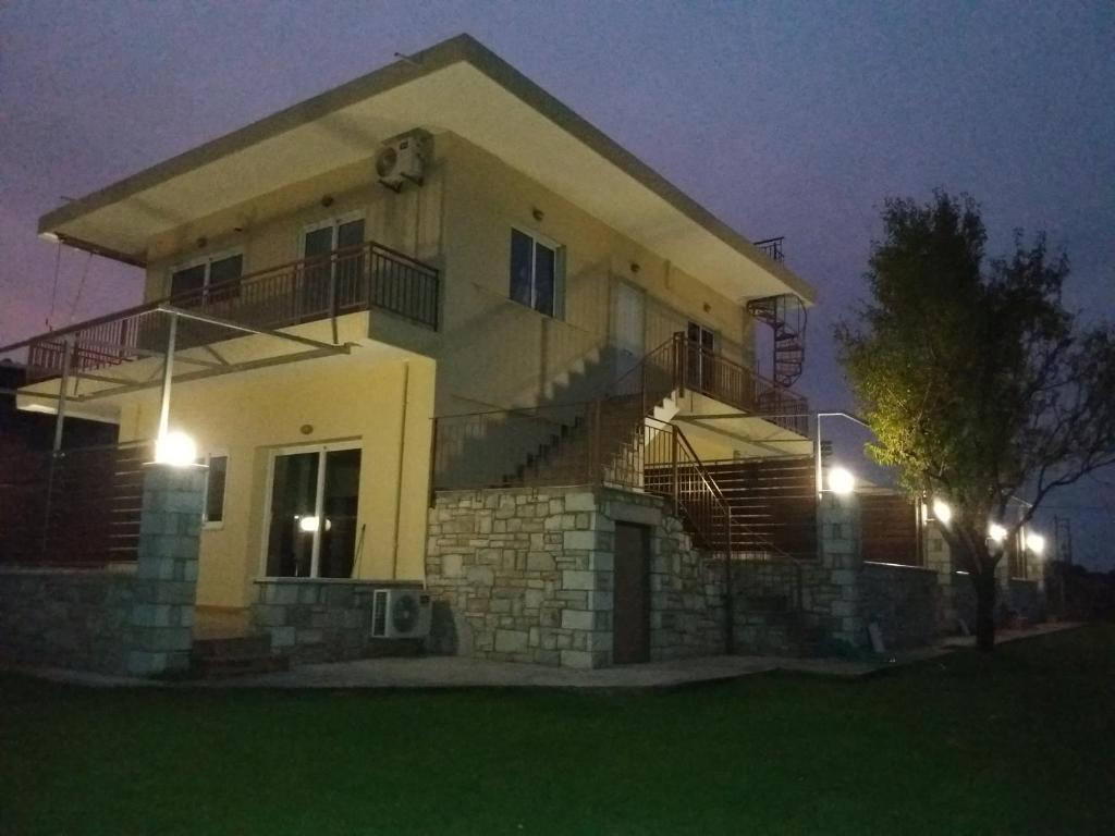 a house with lights on the front of it at Nereids Apartments-Erato in Petalidhion