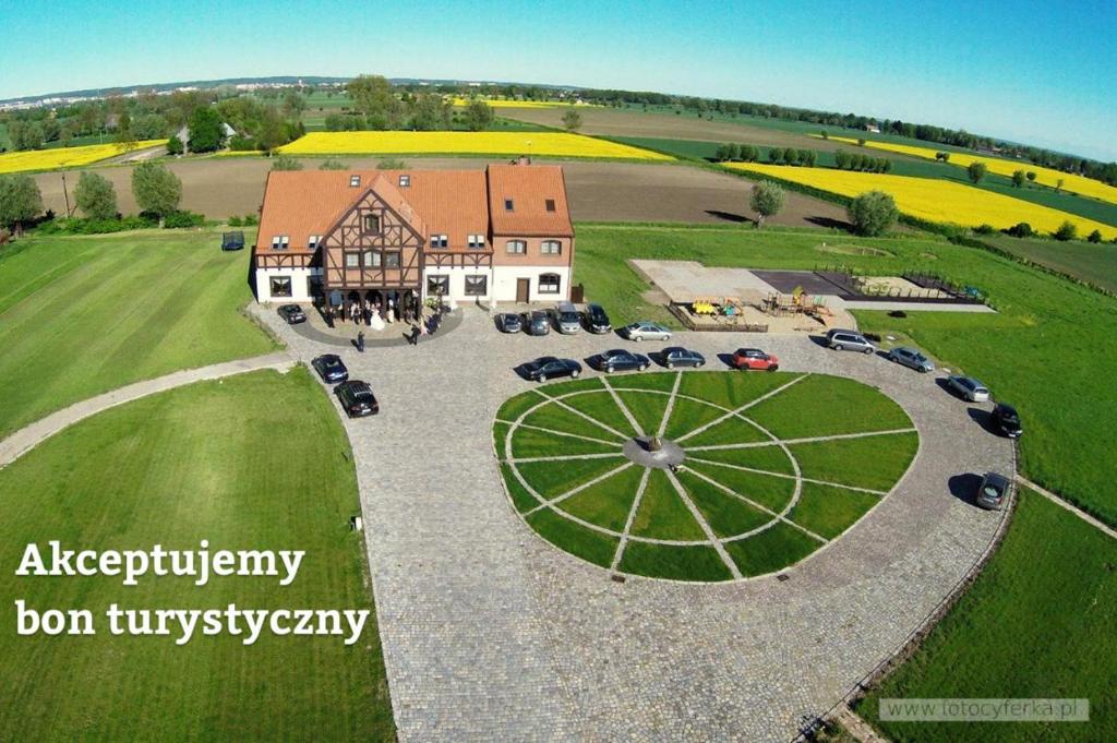 an aerial view of a large house with cars parked around it at Folwark Żuławski in Elblag