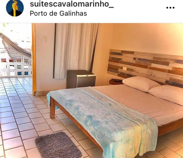 a bedroom with a bed and a tiled floor at Suítes Cavalo Marinho in Porto De Galinhas