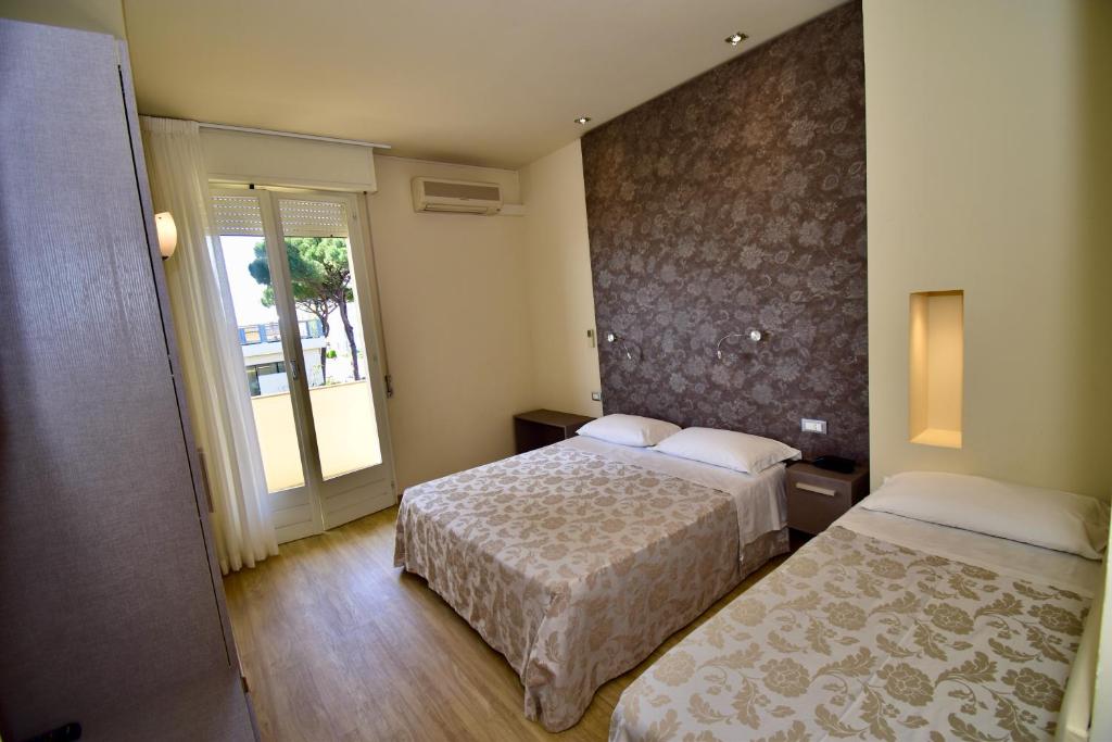 Postel nebo postele na pokoji v ubytování Hotel Astor B&B