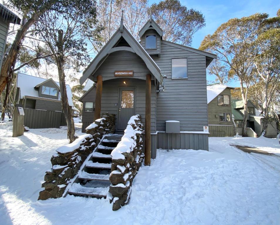 a house in the snow with snow covered steps at High Bernation Haus in Dinner Plain