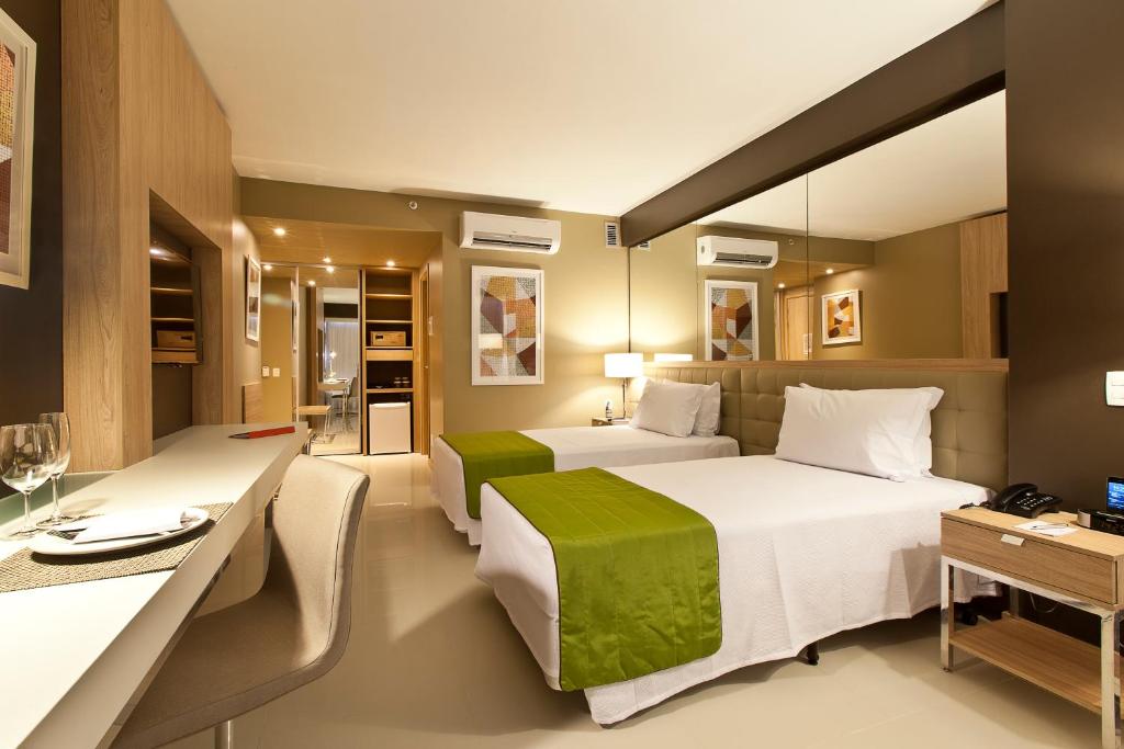Un pat sau paturi într-o cameră la eSuites Savassi Toscanini