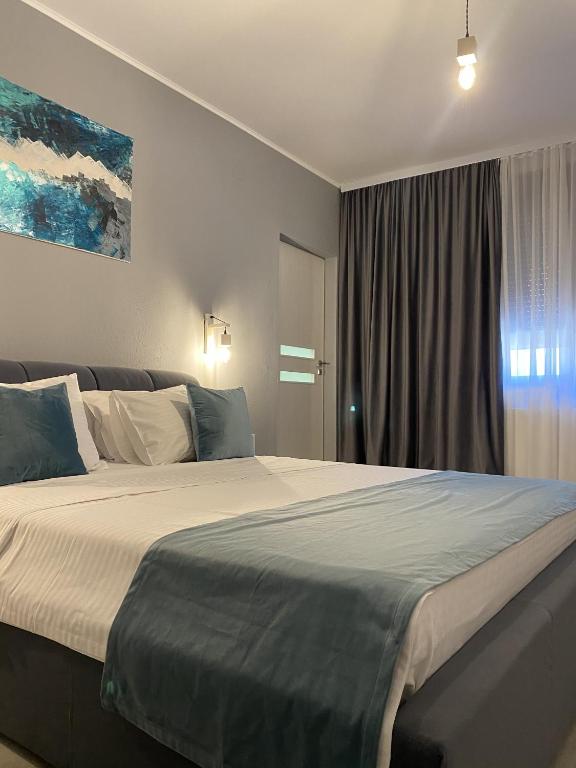a bedroom with a large bed and a window at Roomzzz Sibiu in Sibiu