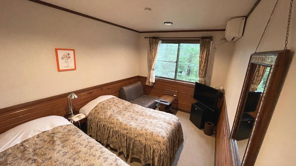 Postel nebo postele na pokoji v ubytování Petit Hotel Kazekozou