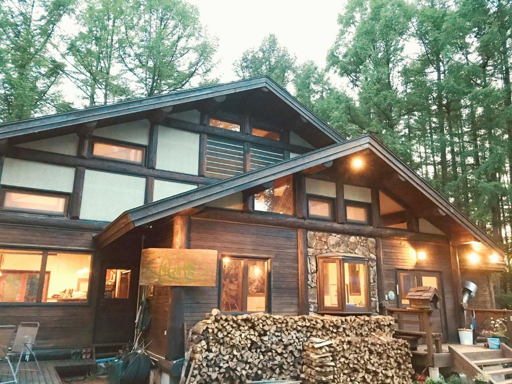 a large wooden house with a lot of windows at Petit Hotel Kazekozou in Shinano