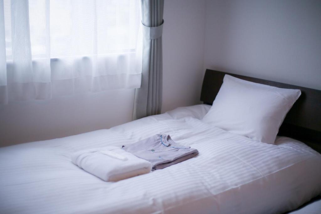 Postel nebo postele na pokoji v ubytování tune Hostel（ツネホステル館山）