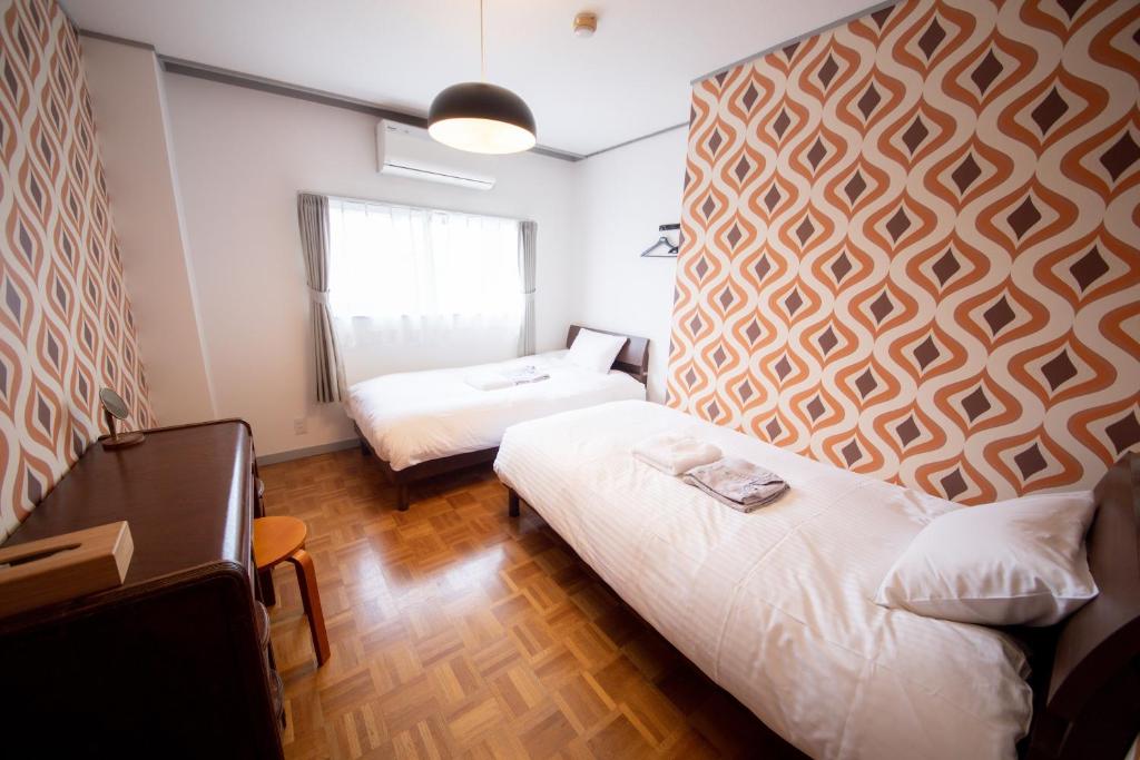 Postel nebo postele na pokoji v ubytování tune Hostel（ツネホステル館山）