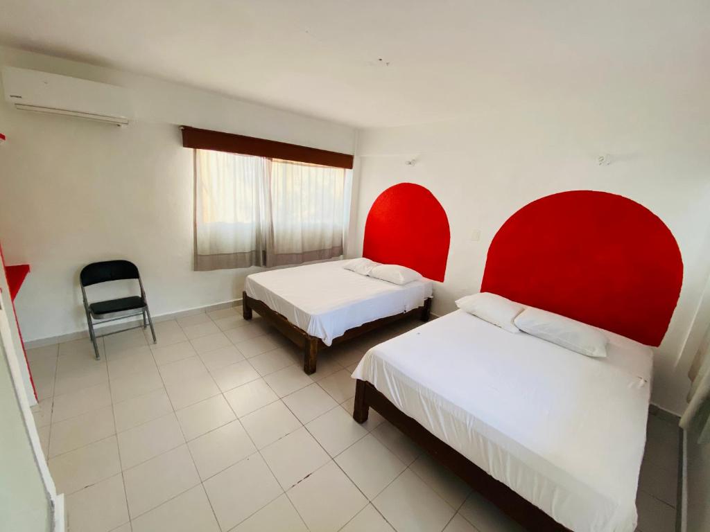 En eller flere senge i et værelse på Hotel Maria Bonita Acapulco