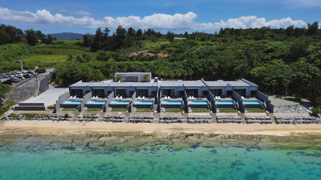 an aerial view of a resort on the beach at Feliz Villa Suite Kourijima View in Nago