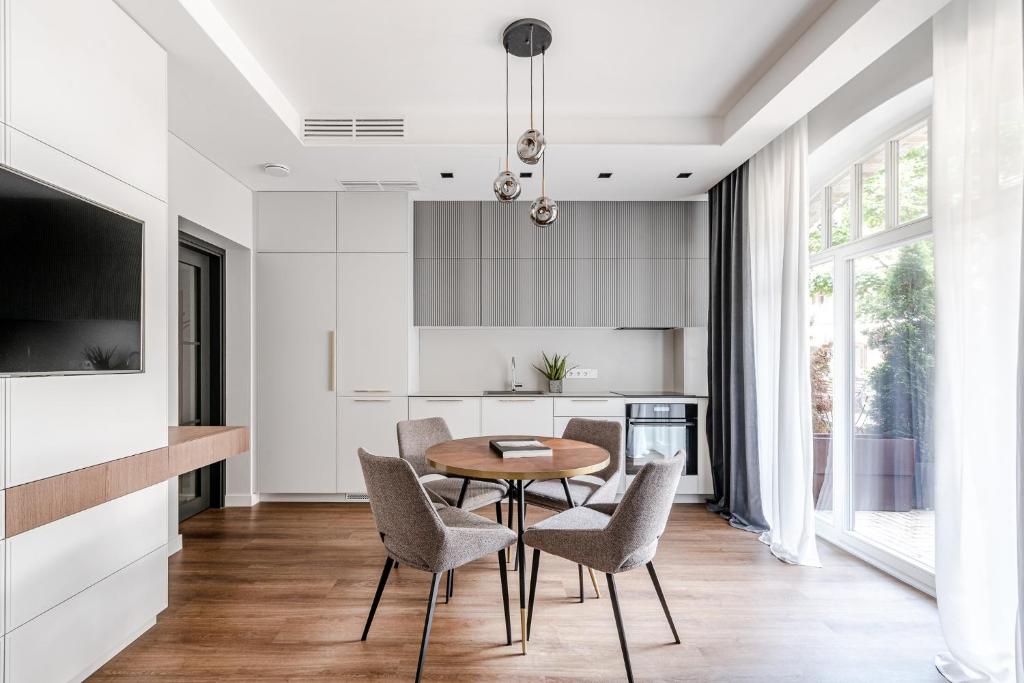 a kitchen and dining room with a table and chairs at Luxurious Apartment in Vilnius Old Town by Reside Baltic in Vilnius