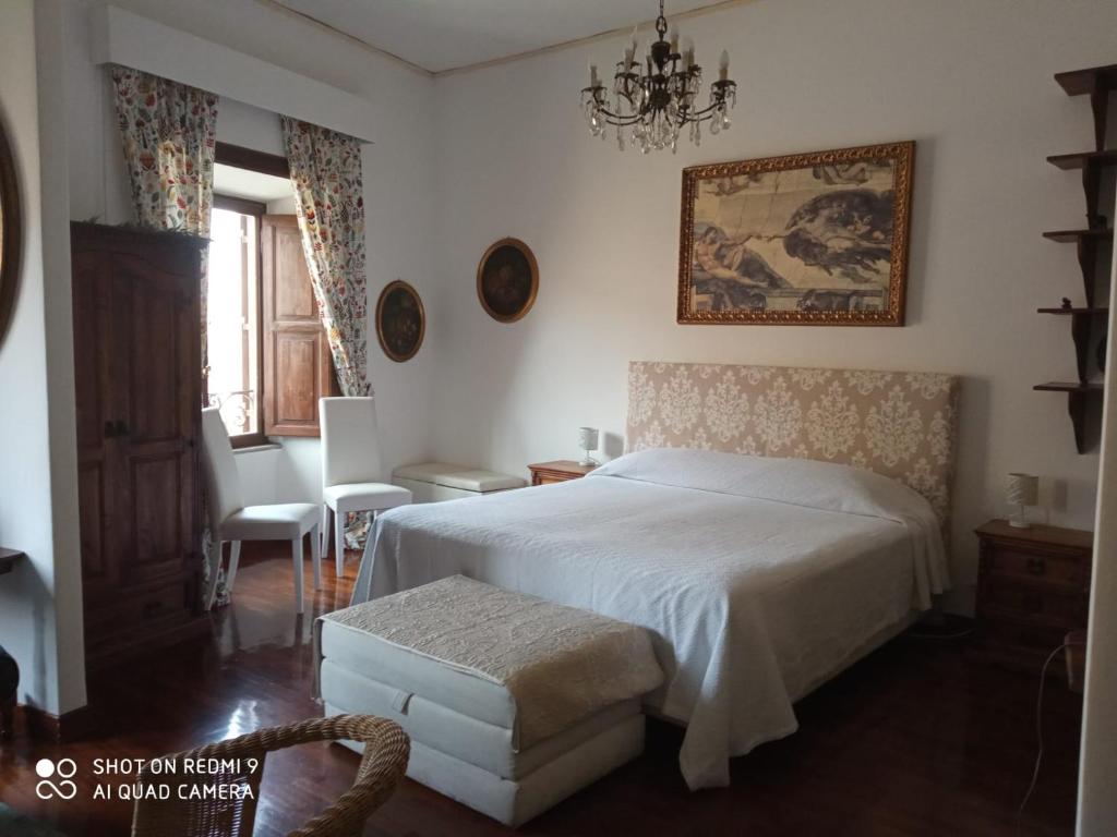 a bedroom with a bed and a table and a chair at Catherine's Home in Rome